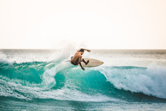 professional surfer riding waves in Bali, Indonesia. men catching waves in ocean, isolated. Surfing action water board sport. people water sport lessons and beach swimming activity on summer vacation