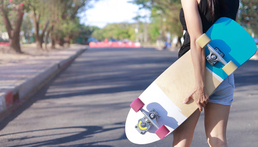 a child holding a surfskate