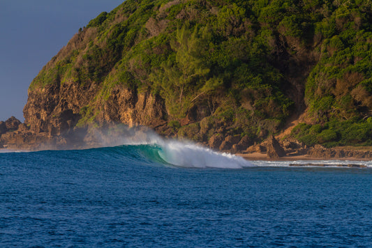 perfect point break wave breaking onto a beach